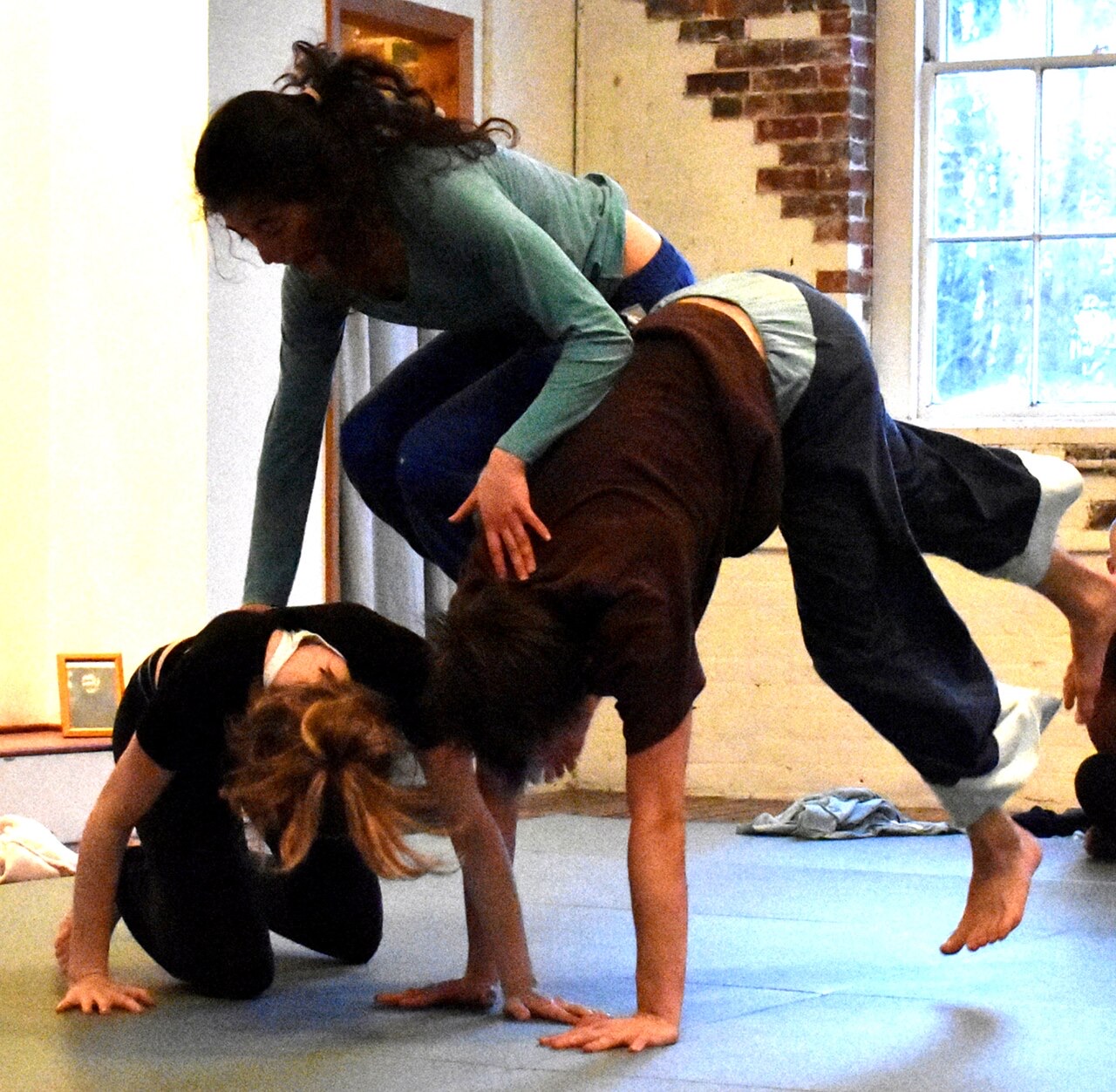 Three people practicing Contact Improvisation at a later workshop