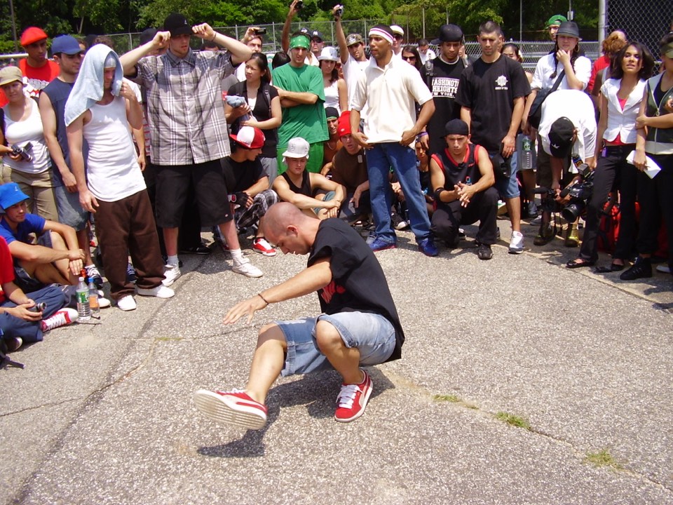 B-boy Pumba Dances in a Bronx breaking cypher as other dancers watch, 2007